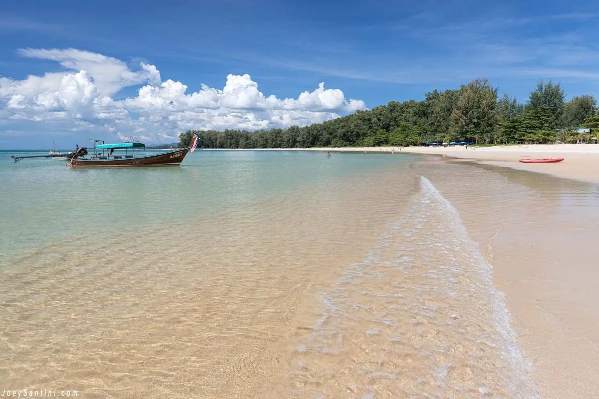 Clear water and a longtail boat off Nai Yang Beach